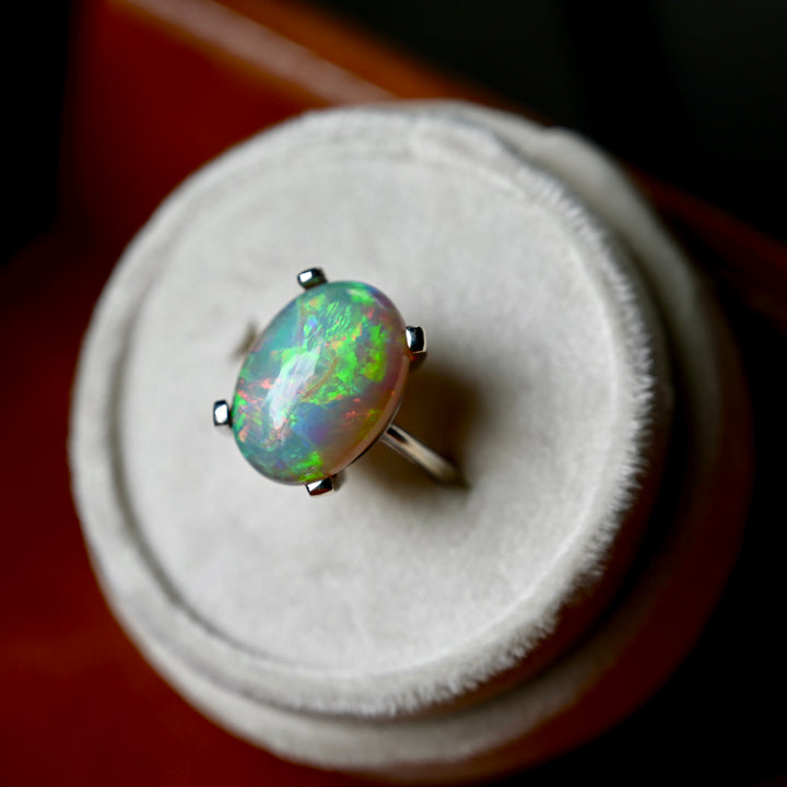Statement ring featuring natural Ethiopian opal with ocean blues sunset reds and greens in white gold OpalOra