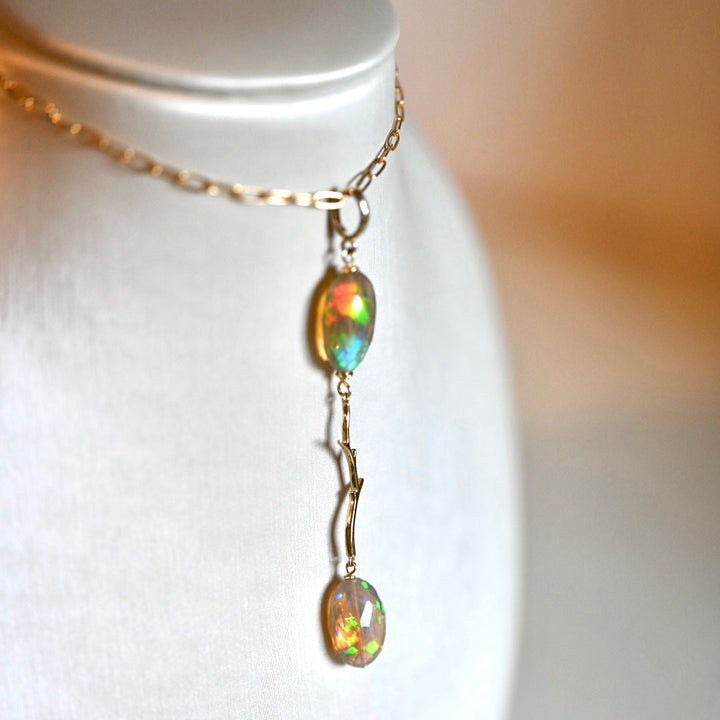 Black opal with reds, blues, yellows and greens, rare opal jewelry. Natural dark opal, natural black opal ethiopian opal. 14 karat solid yellow gold and opal pendant. Modern long necklace. Natural branch jewelry, nature inspired necklace. Black hills jewelry. Opalora jewelry. 