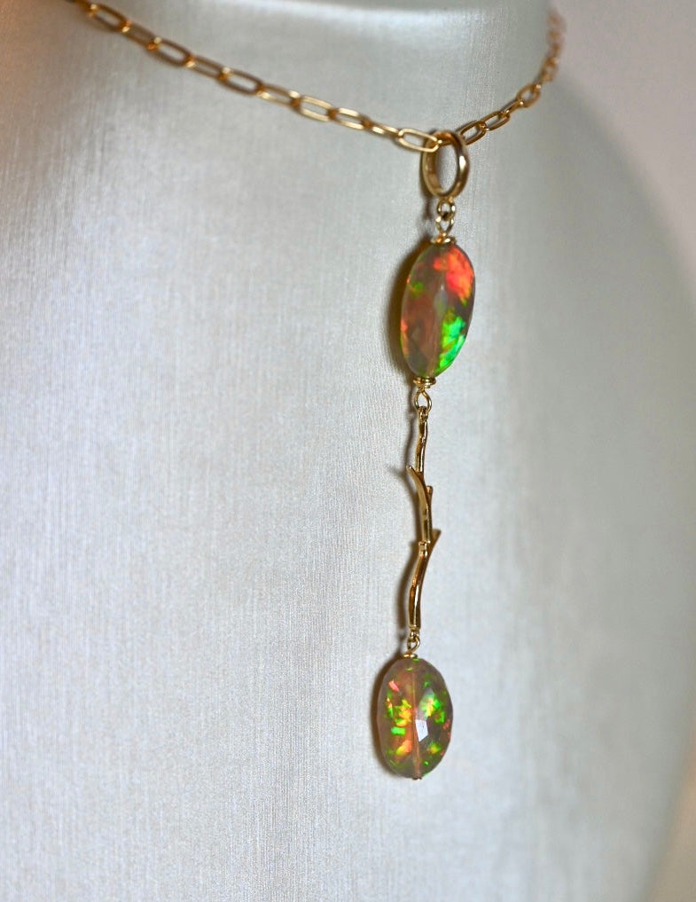 Black opal with reds, blues, yellows and greens, rare opal jewelry. Natural dark opal, natural black opal ethiopian opal. 14 karat solid yellow gold and opal pendant. Modern long necklace. Natural branch jewelry, nature inspired necklace. Black hills jewelry. Opalora jewelry. 