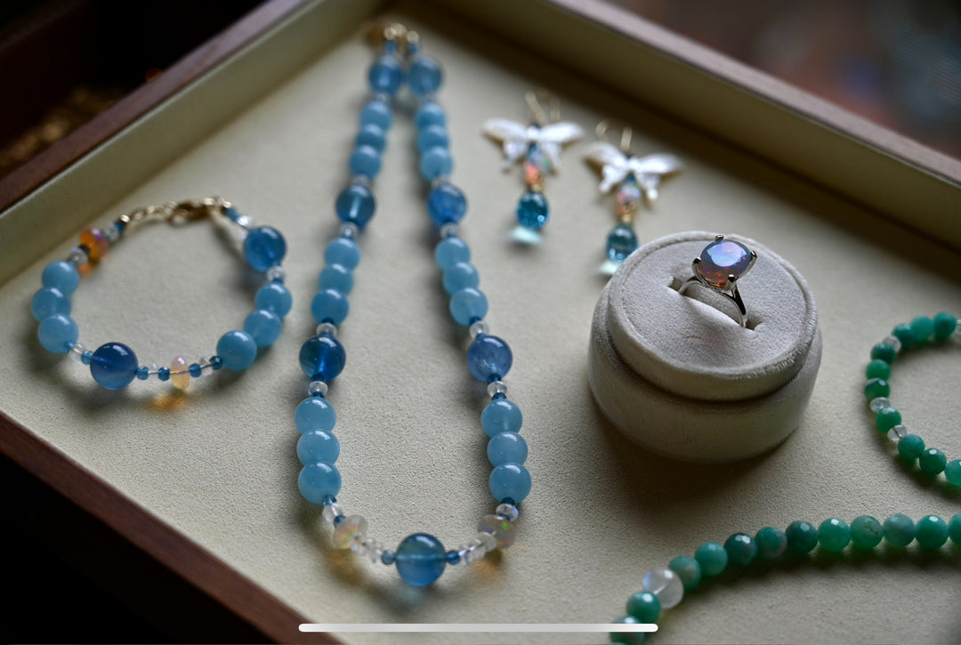 two sets of colorful necklaces. valtasy jewelry. opalora jewelry. blue aquamarine necklace and bracelet set. long earrings with blue topaz and butterfly. rare blue fluorite and aaa aquamarine 14k solid gold jewelry. 14k white gold opal cocktail ring. 14K gold emerald moonstone necklace natural gemstone beaded jewelry handcrafted statement necklace OpalOra