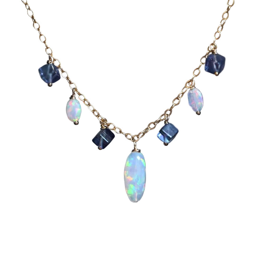 Necklace with opal and blue gemstones on a white background. Handcrafted white opal and purple fluorite beaded necklace by OpalOra with adjustable 18 inch chain.