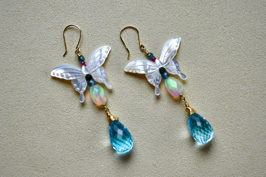 Butterfly symbolism. Butterfly jewelry. Butterfly in 14k gold. 14k Gold earrings. 

Opal, Swiss Blue topaz briolette drops, Mother of Pearl butterfly Earrings in 14K solid Gold. Handmade earrings by opalora jewelry. Long butterfly earrings, gold earrings.