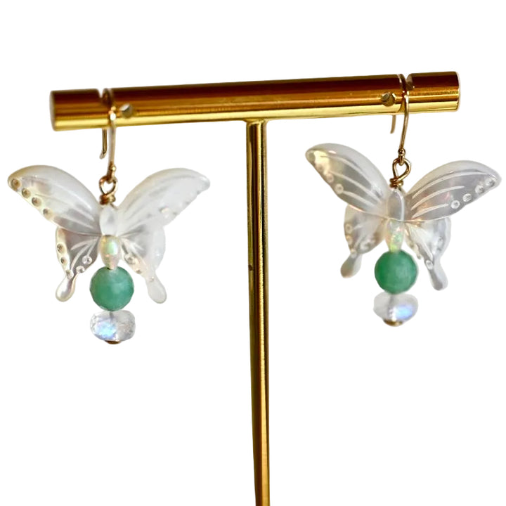 Get ready to flutter away with our exquisite 14K gold earrings featuring natural emeralds, opals, and moonstones in delicate butterfly shapes.

These beauties dangle at a length of 1 1/2 inches, perfect for adding a touch of whimsy to any outfit.