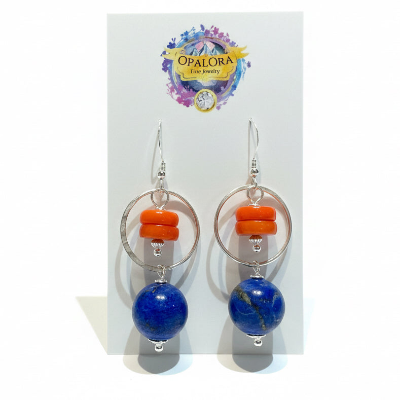 Earrings with orange and blue beads on a Opalora branded card. lapis and coral earrings in sterling silver