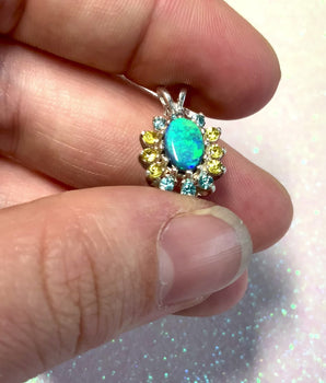 lightning ridge black opal. black opal with blue and green. solid black australian opal necklace. australian opal pendant. australian opal jewelry. blue zircon. yellomsapphire. sunburst pendant. sunburst creation jewelry.
