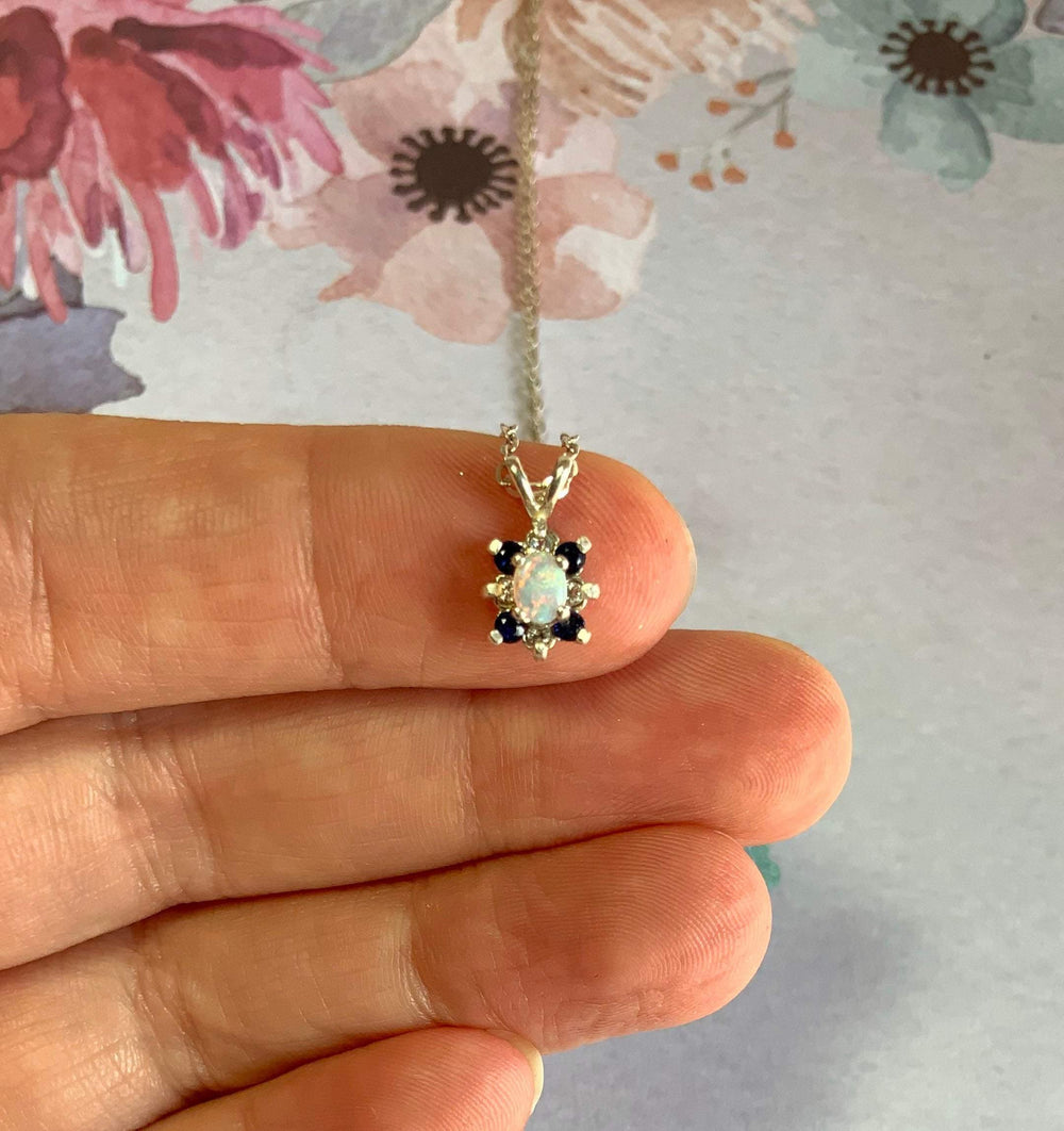 Petite opal necklace with white and blue sapphire accents, handcrafted by OpalOra

